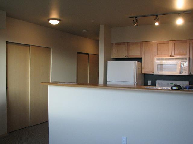 IMG_4638 View of the bar area, kitchen, and closets from the living room.