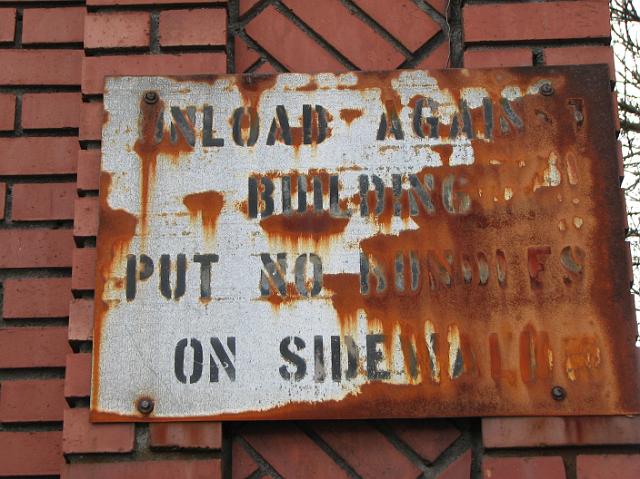 IMG_5391 Old rusted sign on the side of the building